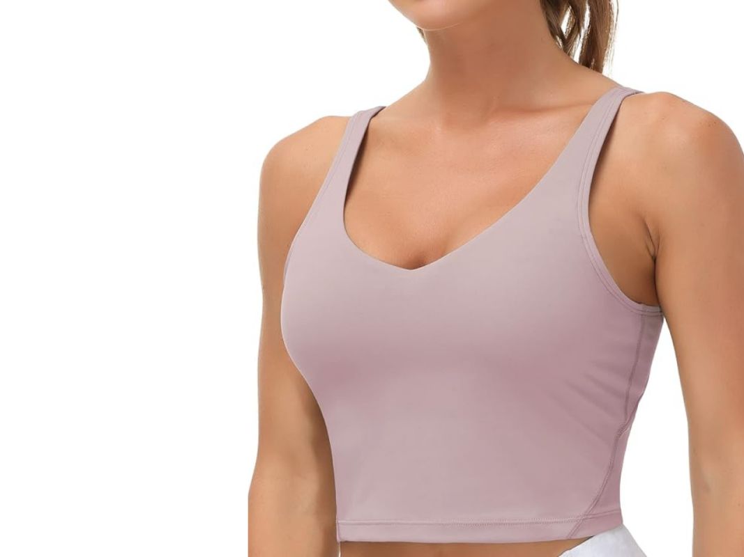 This image features a woman's torso wearing a tight mauve colored tank top.