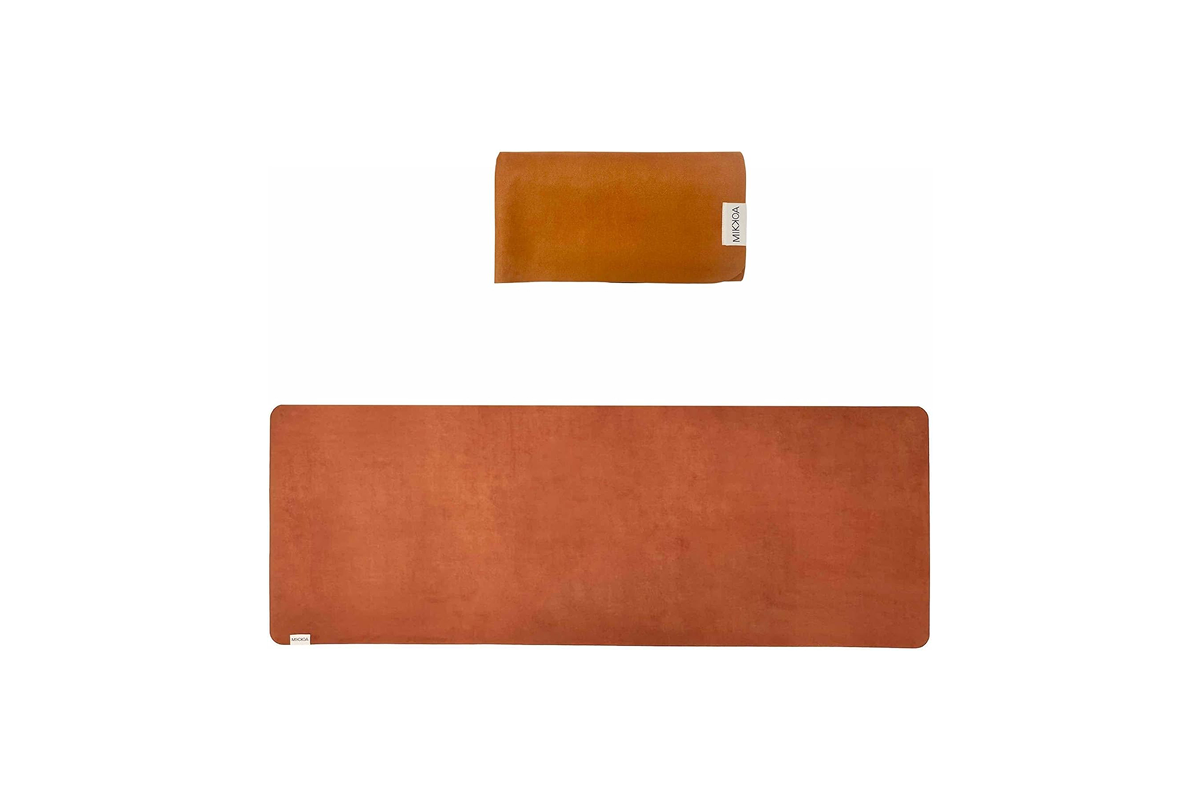 A brown folded yoga mat, above a brown,, unfolded yoga mat.