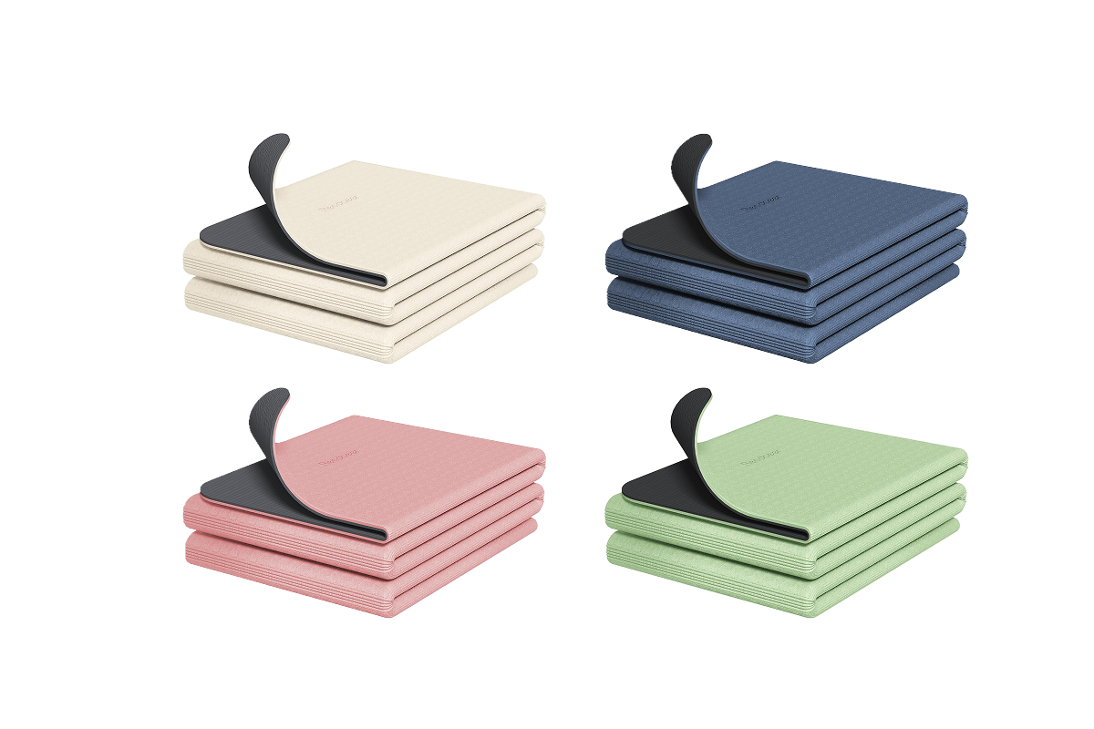 This image shows four folded yoga mats in white, pink, blue, and green.