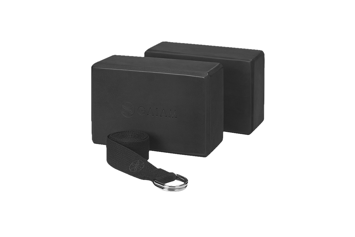 Two black foam blocks next to a black strap with a silver buckle.
