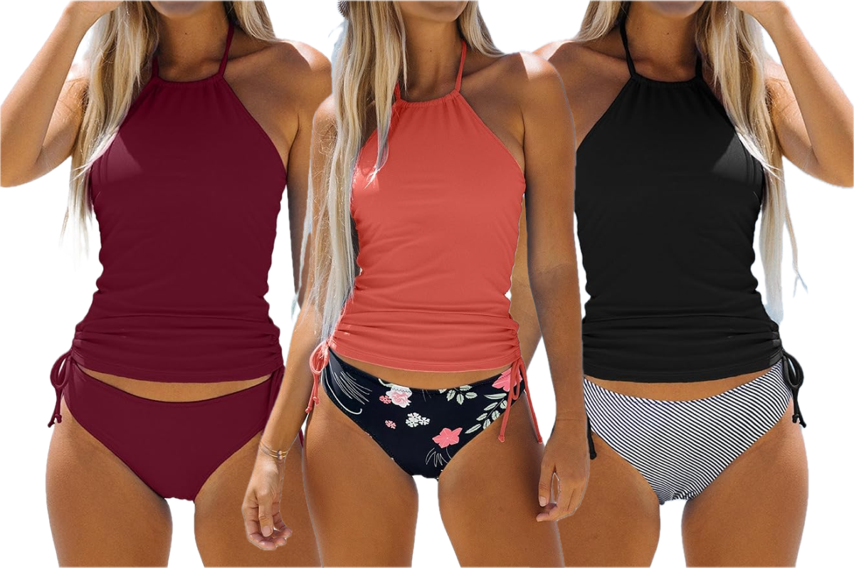 Three women, all wearing tankini style bikinis. Woman at the far left has on a solid maroon colored set. The woman in the middle is wearing a salmon pink colored top with a black and floral bottom. The woman on the right is wearing a solid black top with black and white striped bottoms.
