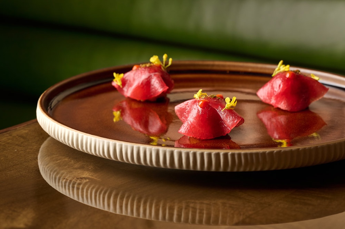 A plate of small bites topped with herbs.