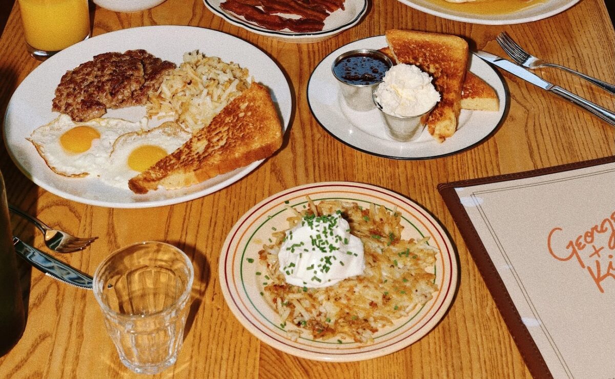 A tablescape with plates of breakfast food.