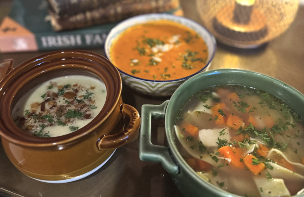 Three bowls of different soups.