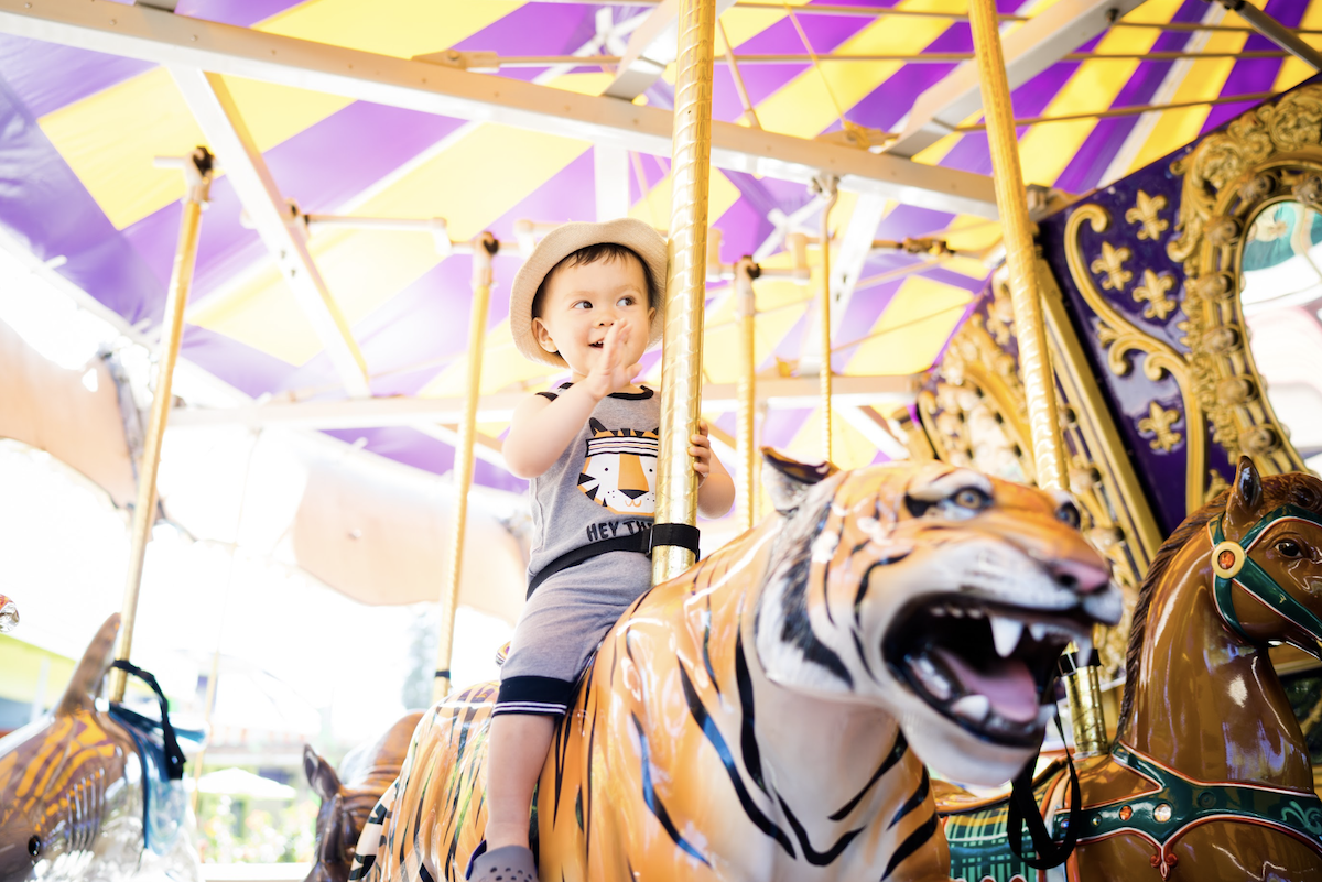 Child riding amusement park ride at Happy Hollow Park and Zoo