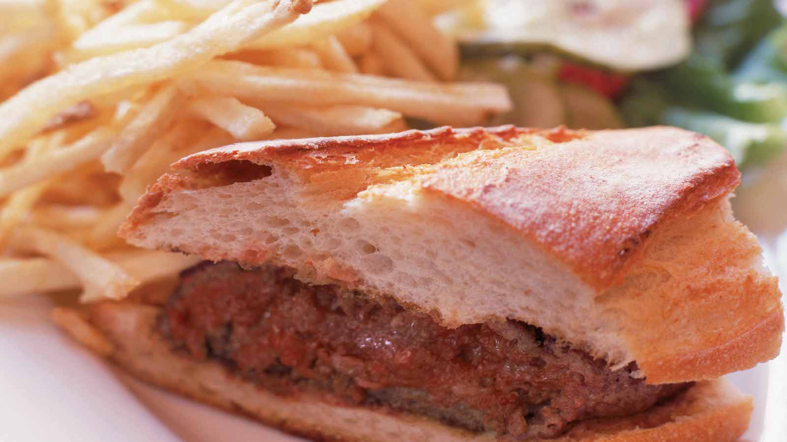 Balboa cafe's classic burger served on a baguette with housemade pickles and shoestring french fries.