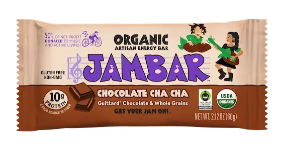A JAMBAR organic artisan energy bar wrapper with "Chocolate Cha Cha" flavor. Contains 10g of protein, gluten-free and non-GMO. The wrapper features cartoon dancers with musical notes, stating proceeds are donated to music and active living. Net weight: 2.12 oz (60g).
