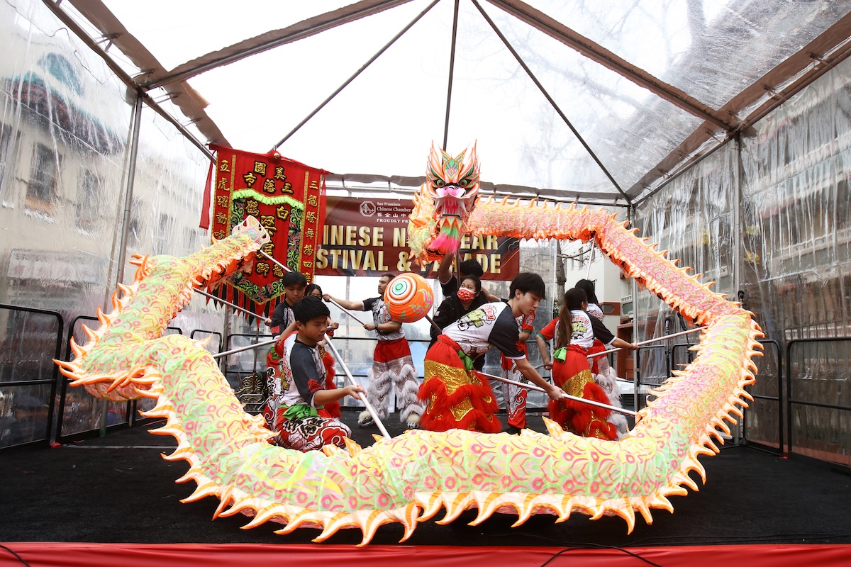 Teenagers dance with dragon puppet at Chinatown Street Festival for Lunar New Year
