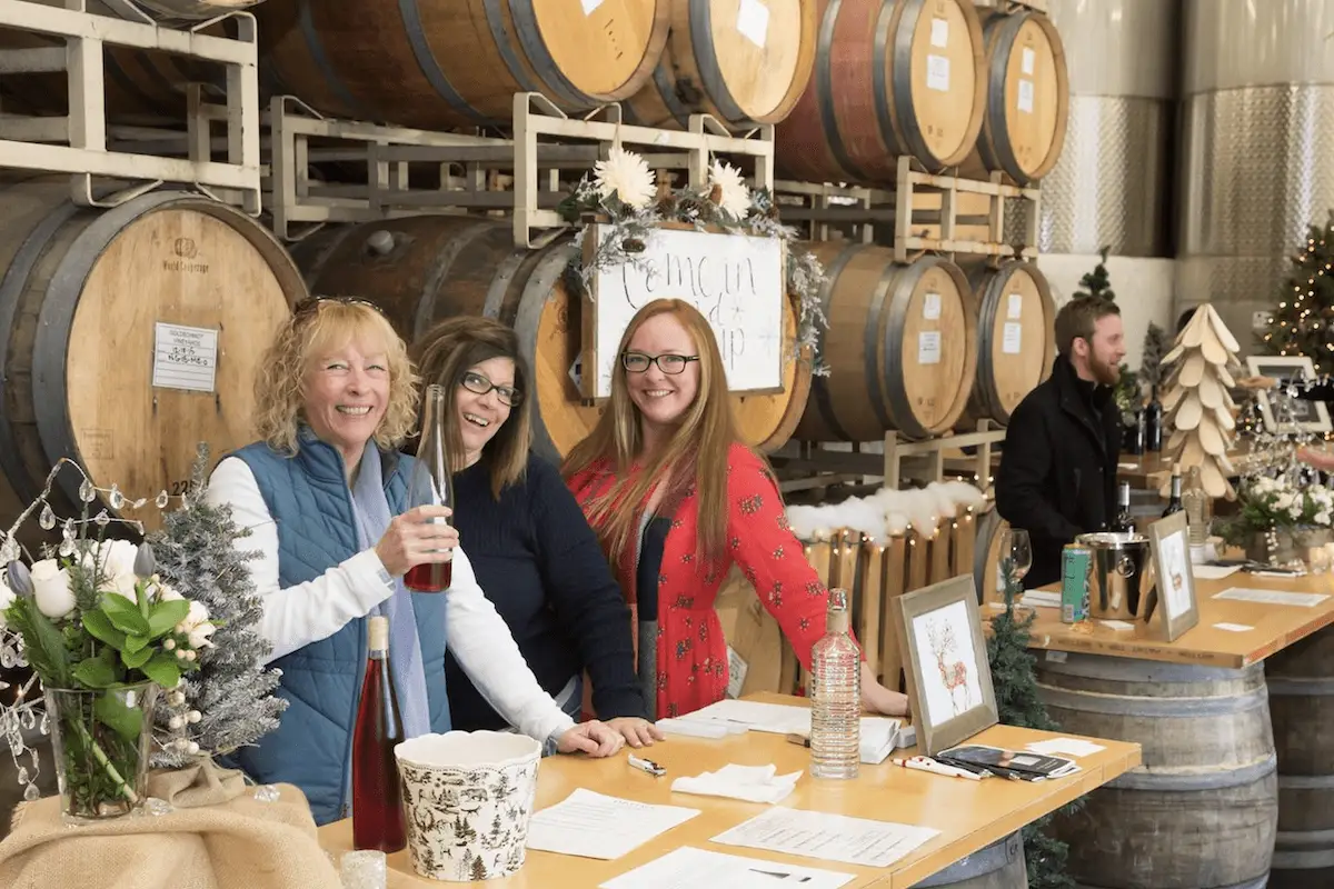Wine sellers smile at Wine Road Barrel Tasting in Sonoma Wine Country