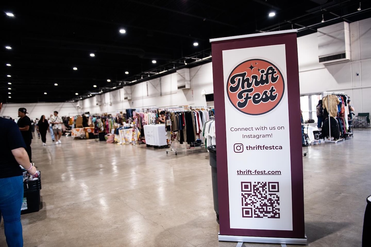 Poster that says "Thrift Fest" in a warehouse full of secondhand vendors