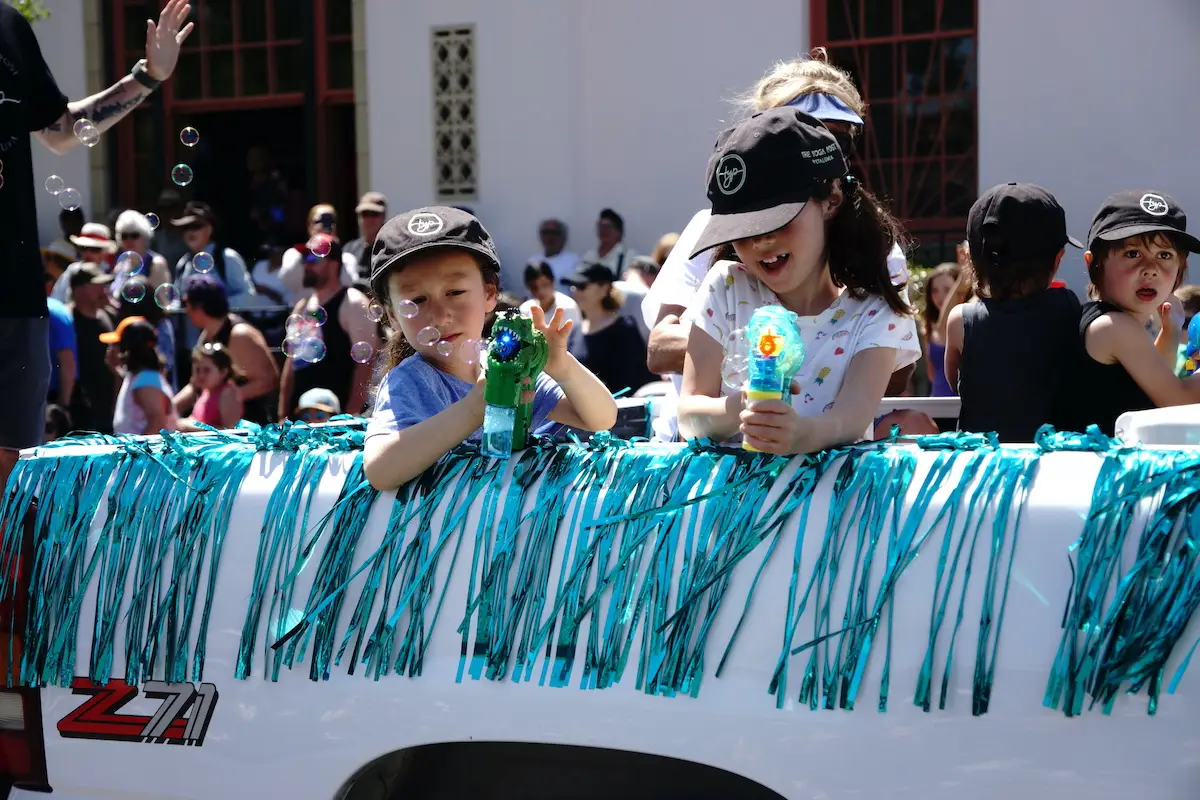 Kids use bubble guns at the Butter and Eggs Day Parade in Petaluma, California.