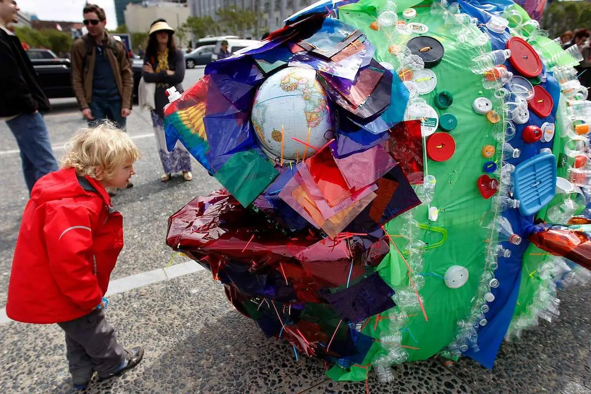 Boy looks at art piece made of trash at Earth Day SF in San Francisco, California