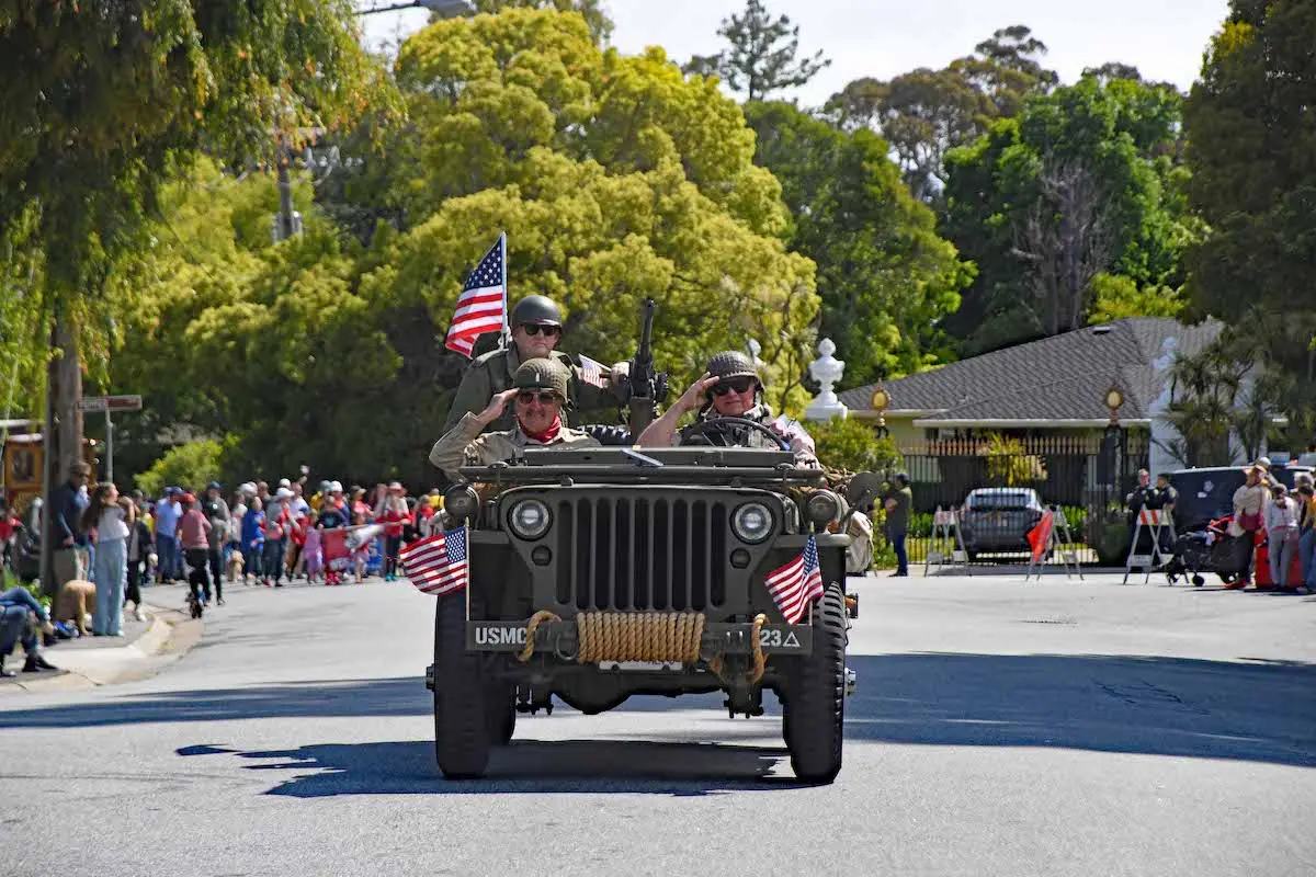 Military vehicle with veterans driving down the street in Memorial Day Parade in Hillsborough, California