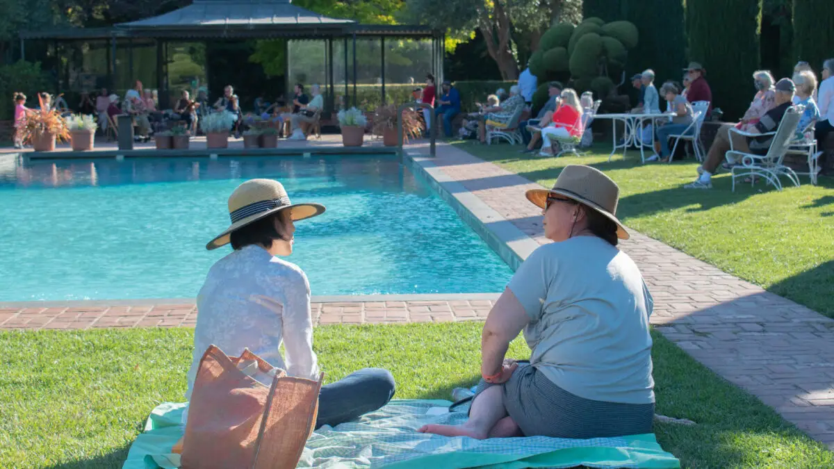 Two people converse by pool at Filoli Estate in South Bay