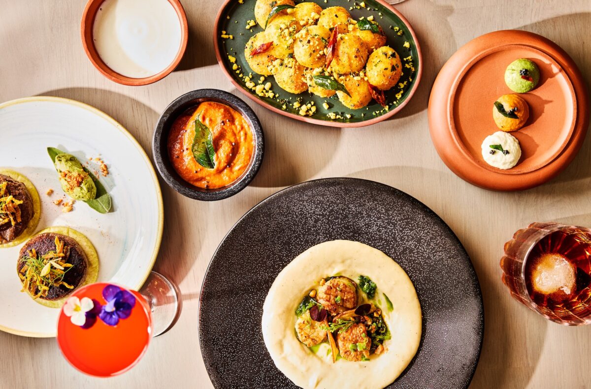 An aerial shot a tablescape with plates of food and bowls of dips.