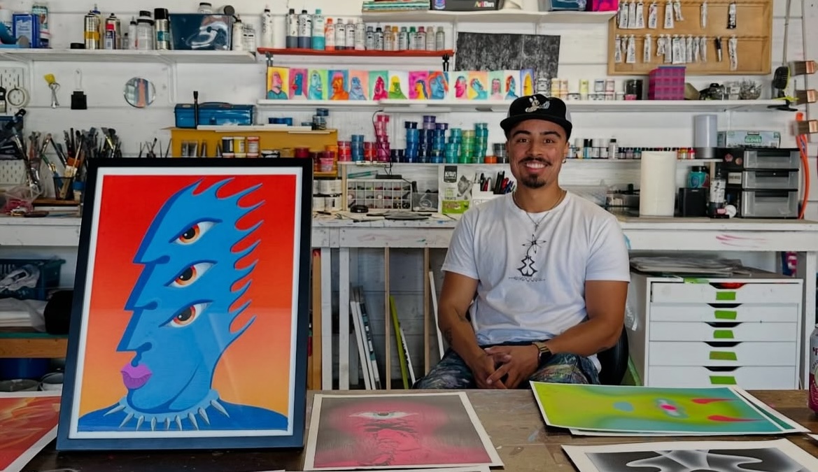 A young East Bay artist sits at a work station for East Bay Open Studios