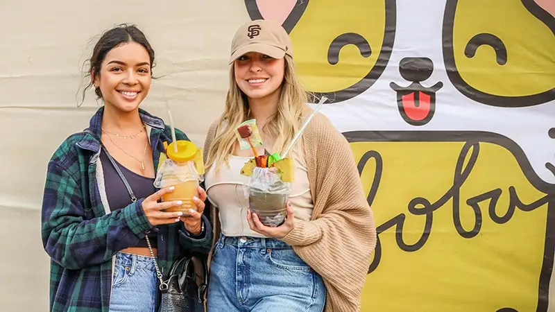two girls enjoying their drinks at Foodieland festival