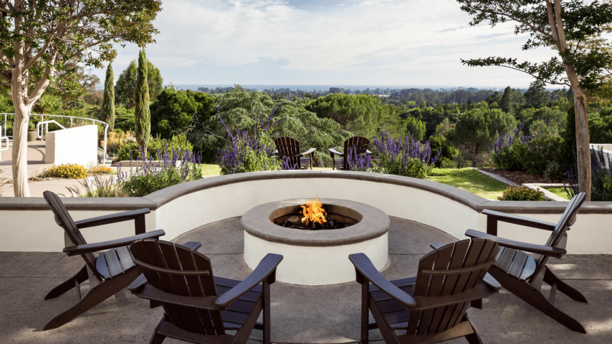 Fire pit and two chairs on the patio at Chaminade Resort and Spa in Santa Cruz, California.