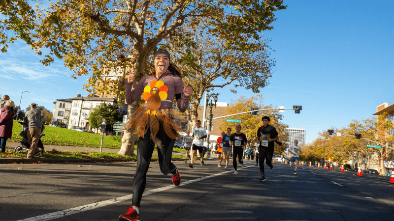 Runner in turkey costume runs at Oakland's Thanksgiving Turkey Trot event