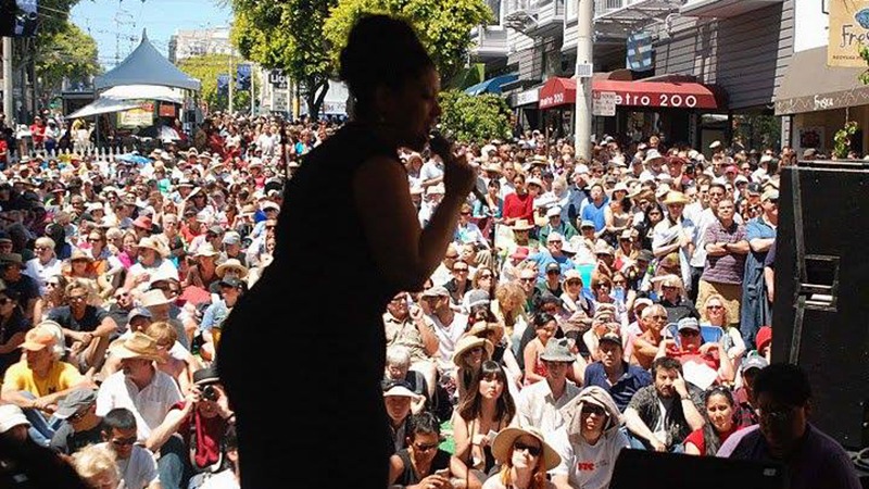Singer on stage in front of audience at Fillmore Jazz Festival