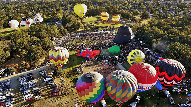 Aerial view of hot air balloons above crowds for Hot Air Balloon Classic in Sonoma County, California.