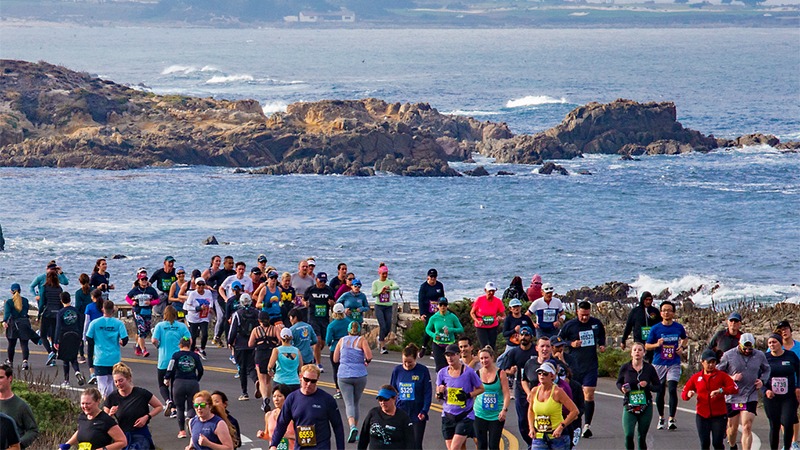 Runners on coastal road for Monterey Bay Half Marathon