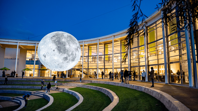 Full moon hangs over Napa Valley Lighted Art Festival in February.