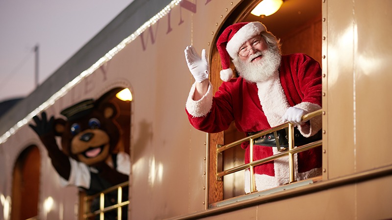 Santa and a giant teddy bear waves from Napa Valley Wine Train.