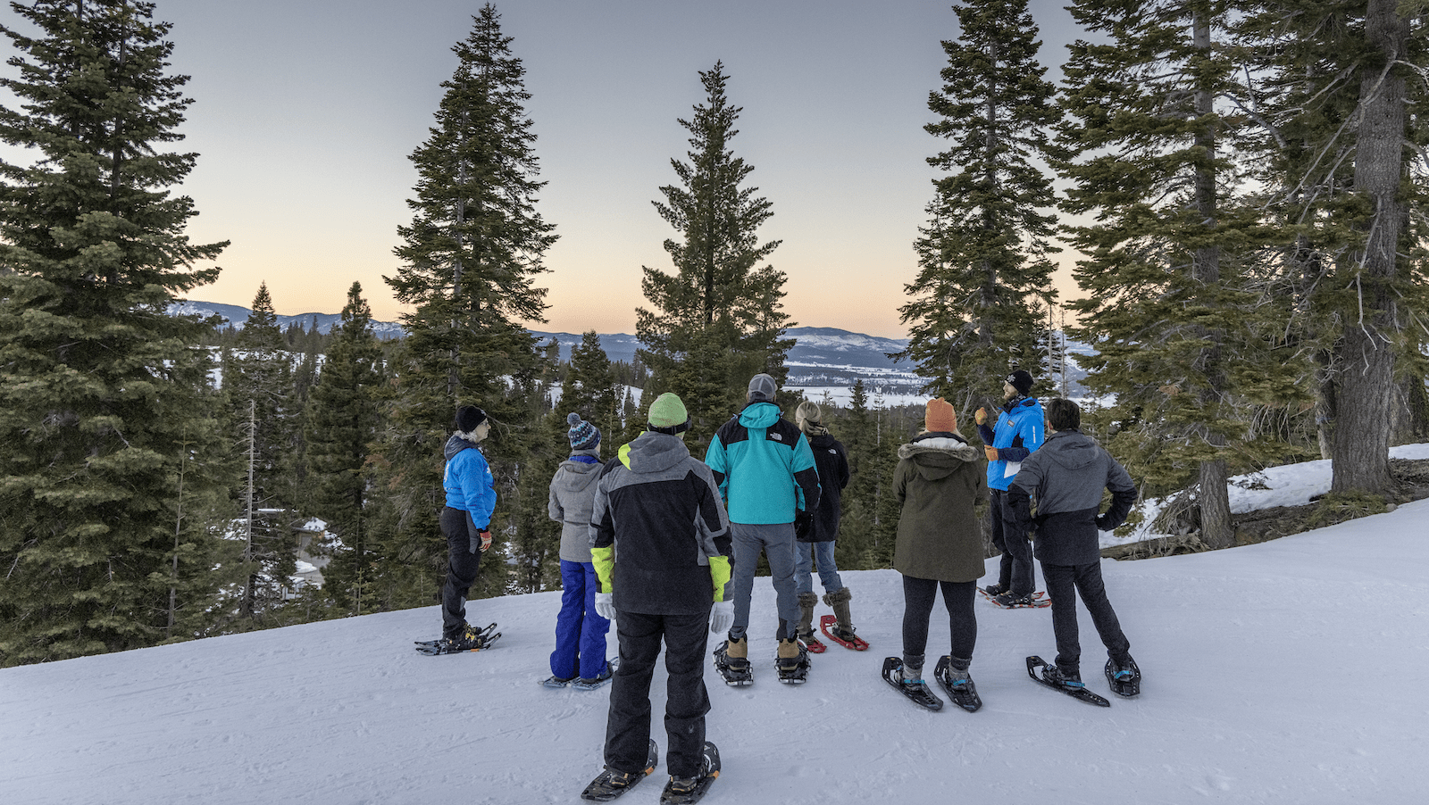 Snowshoers look at Lake Tahoe at Northstar's Twilight Snowshoe Tour