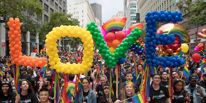 Parade goers hold balloons that spell out "LOVE" at San Francisco Pride Parade