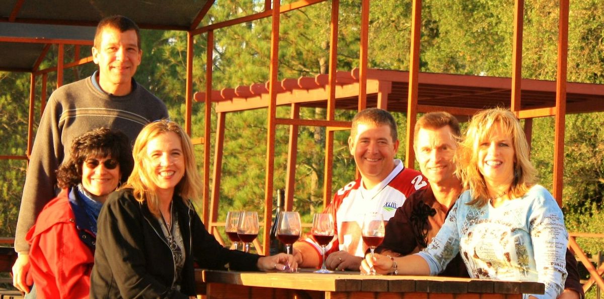 People smile at table with wine glasses for Sonoma County's Wine and Food Affair in California