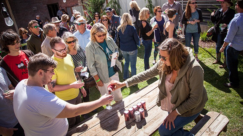 Woman pours drink at Truckee Wine Walk and Shop