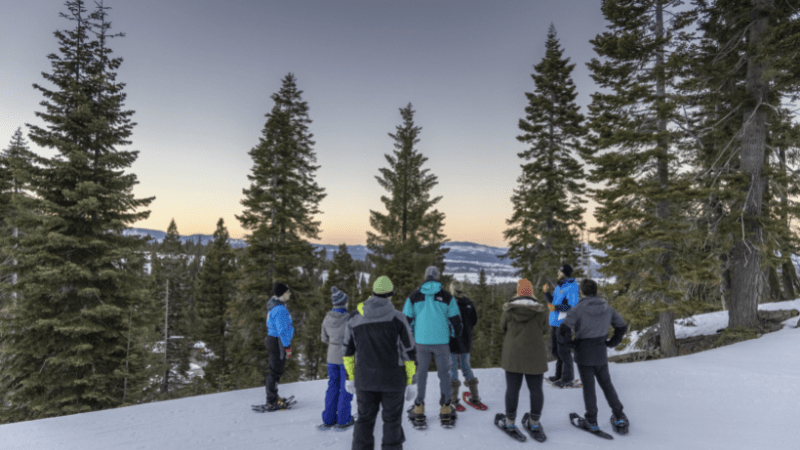 Skiiers look over vista of Lake Tahoe in Truckee's Snowshoe Tour