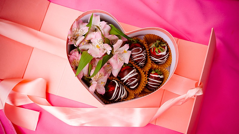 Heart-shaped box of chocolates and flowers