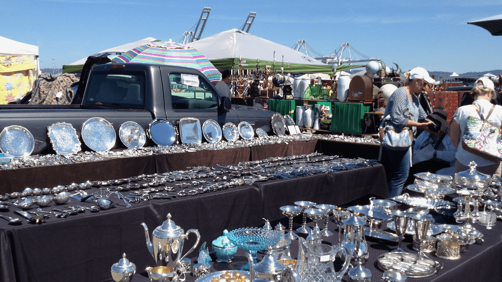 Tables of silverware at Alameda Point Antique Sale