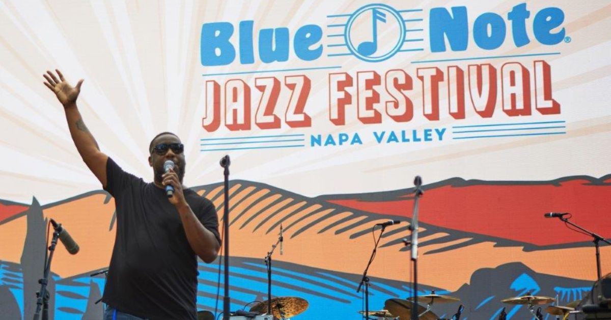 Man holds microphone at Blue Note Jazz Festival in Napa Valley during July