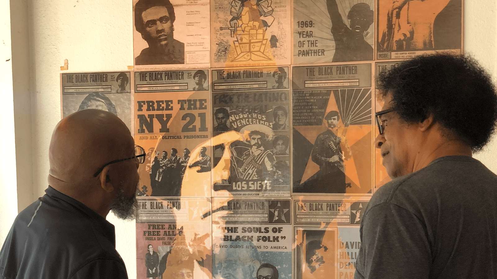 Two people look at Black Panther Party Museum exhibit