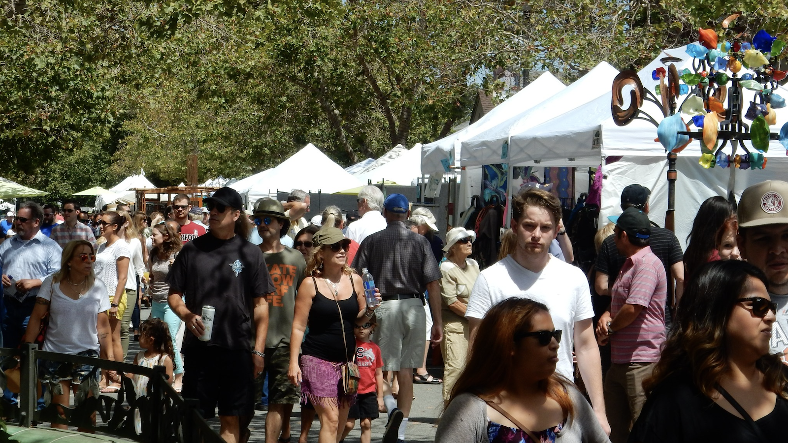People walk through crowd at Palo Alto Festival of the Arts