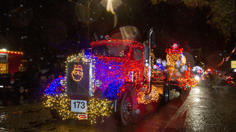 Firetruck covered in Christmas lights for Sonoma county lighted tractor parade for the holidays, in California