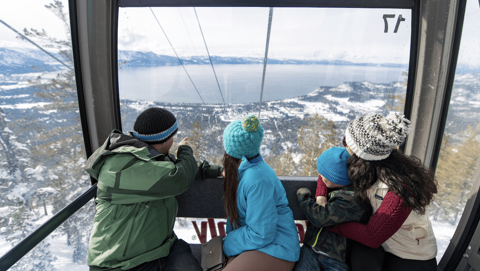 Gondola riders look at view of Lake Tahoe