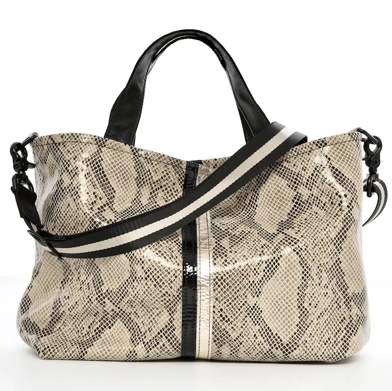 A stylish Lynn Tallerico handbag with a snake-skin pattern in shades of beige and black. The bag features two black handles and a black and white striped shoulder strap. The design includes a black vertical stripe down the center for added detail.