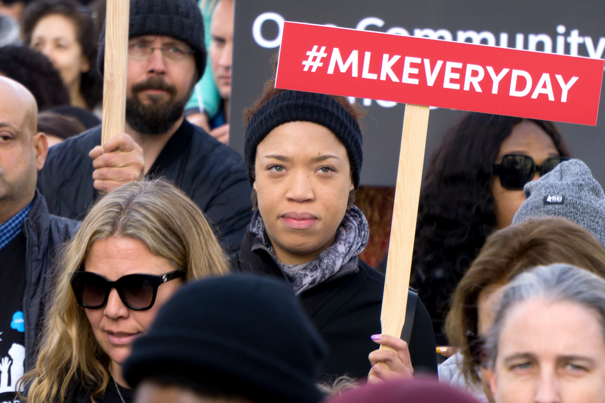 Marcher in the San Francisco Martin Luther King March holds sign that reads #MLKEveryDay