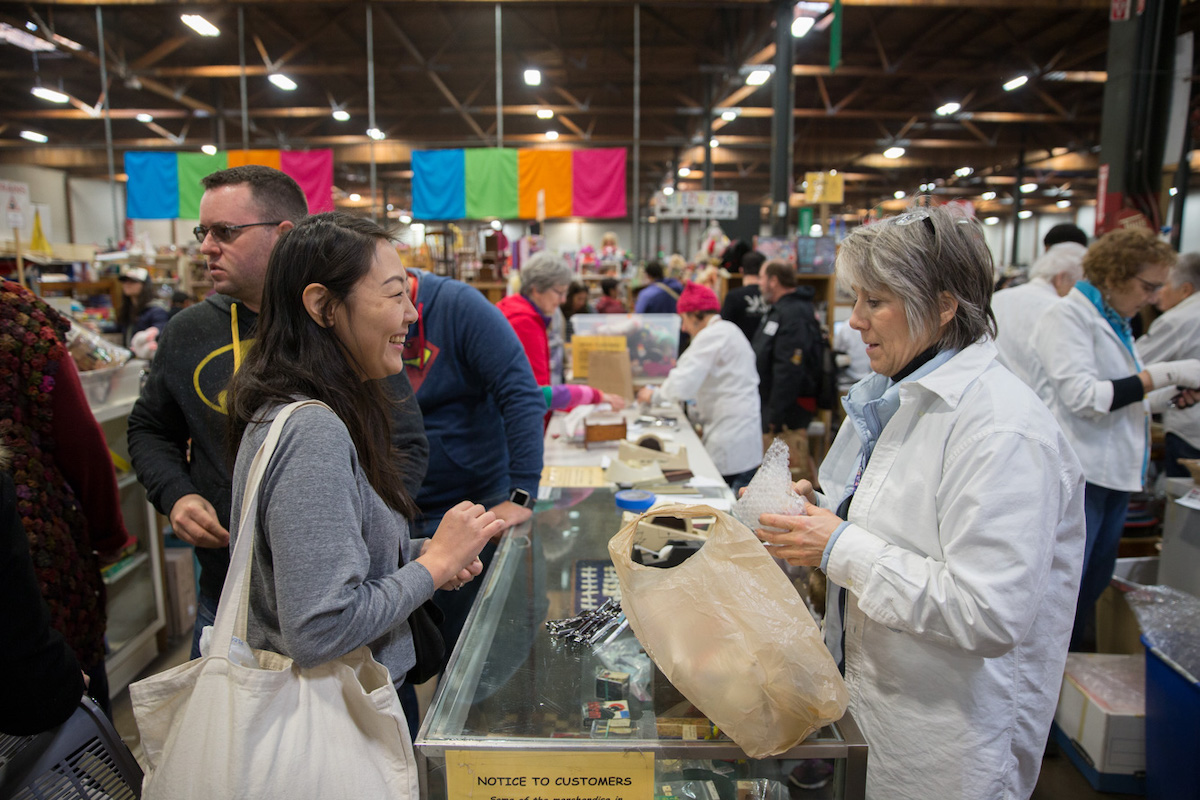 Buyer and vendor interact at Oakland Museum of California's White Elephant sale