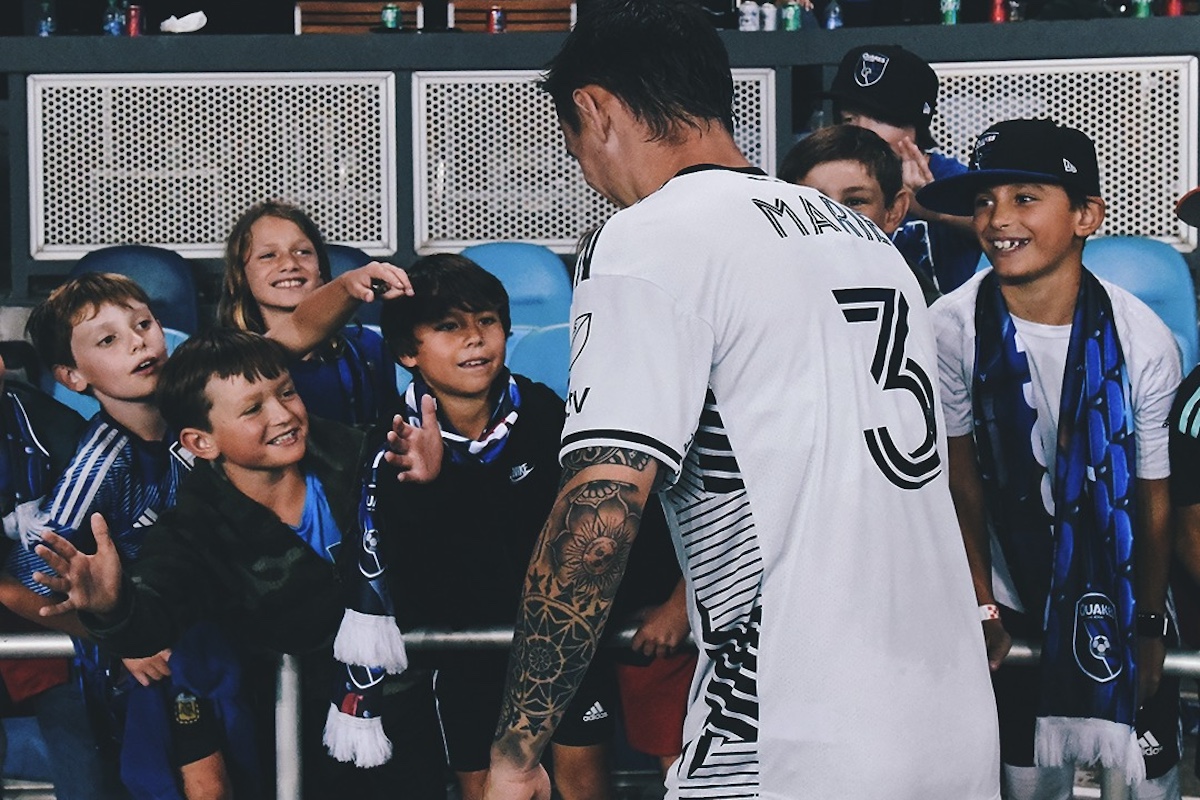 San Jose Earthqueakes Player greets kids at game