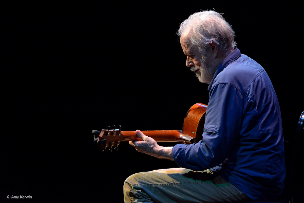 Leo Kottke playing guitar in concert for the Golden State Theatre in Monterey, California.