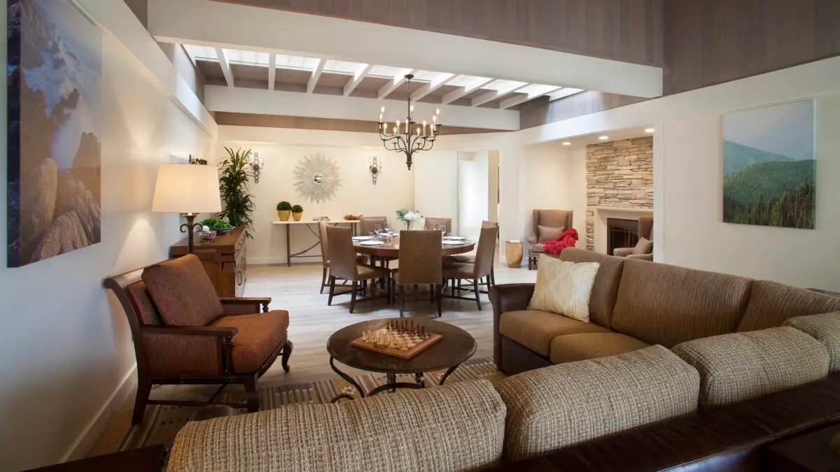 A guestroom with a couch and many chairs in the Villa parlor at Quail Lodge in Carmel, California.