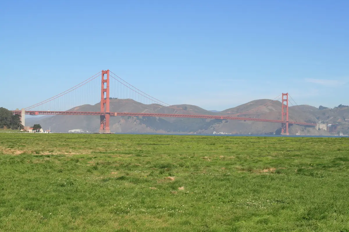 View of the Golden Gate Bridge from the green Crissy field in San Francisco
