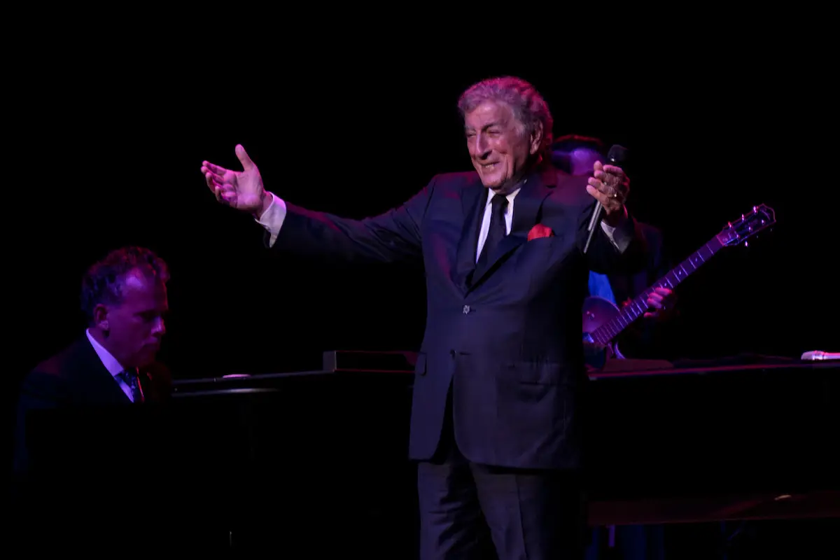 Tony Bennett performing with arms open