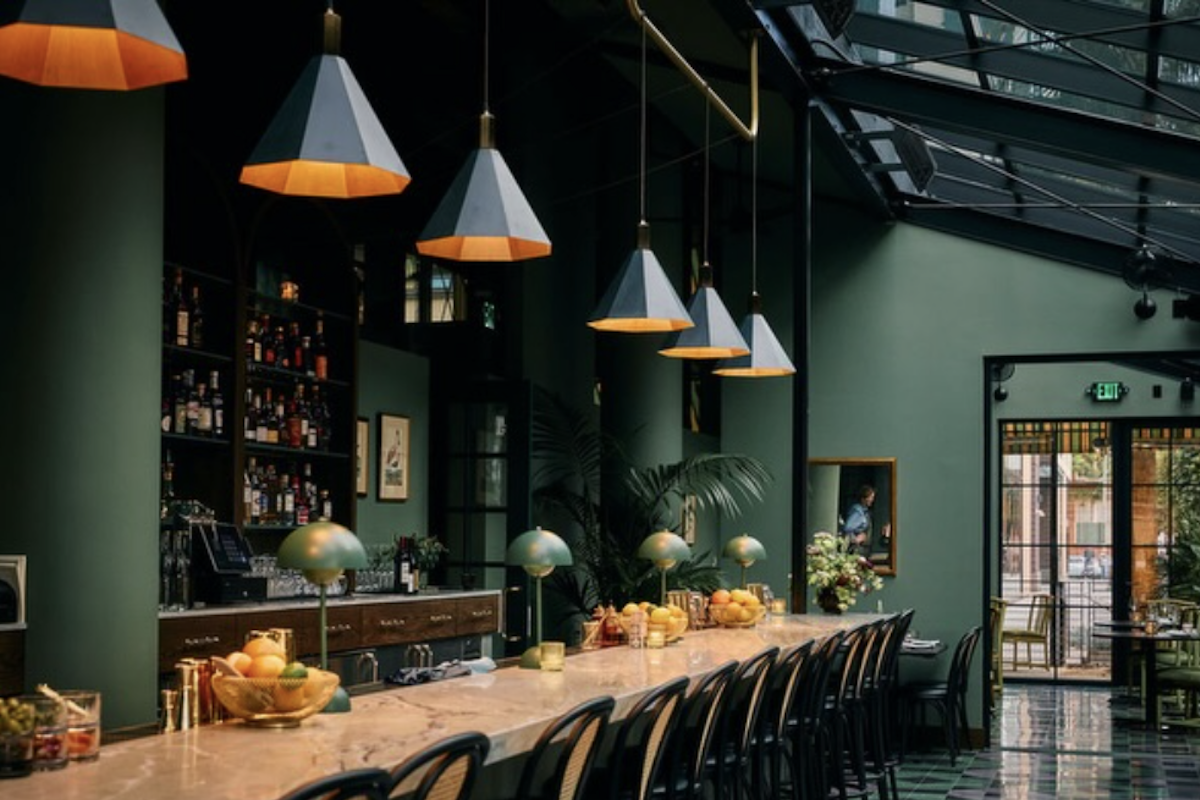 The bar of a restaurant with ambient lighting.