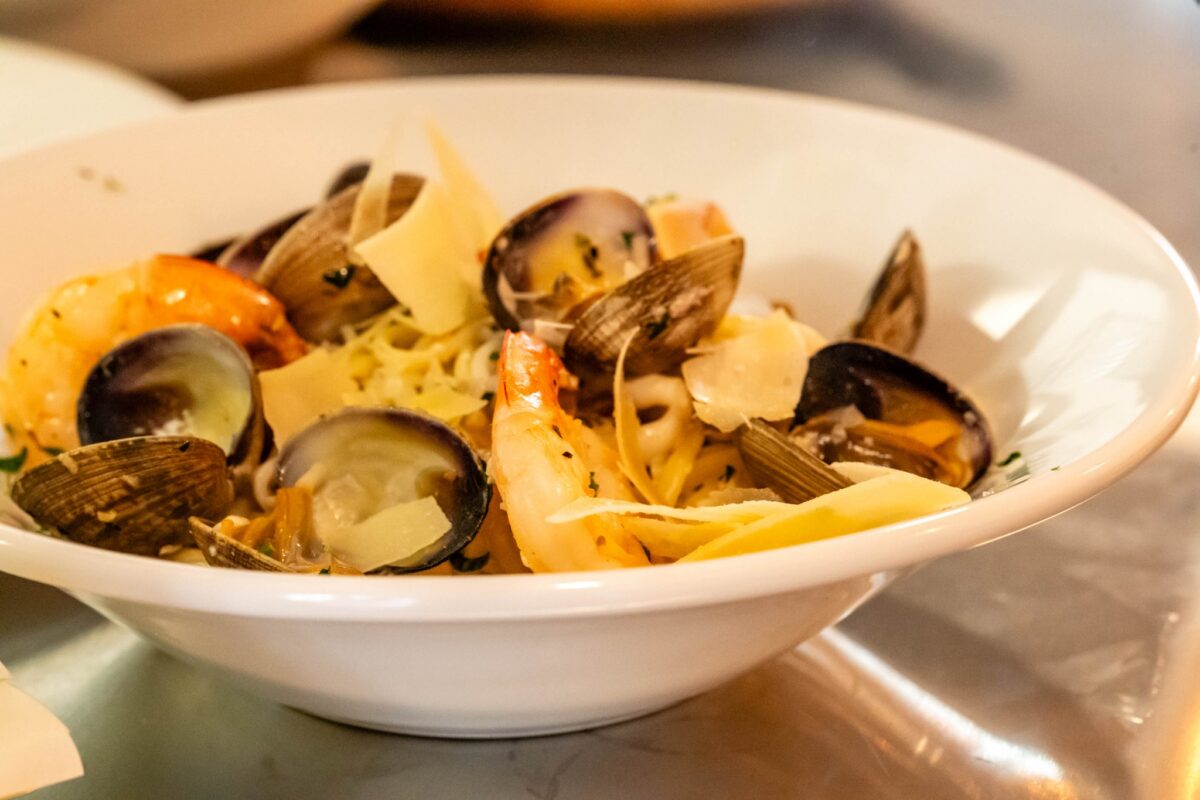 A closeup shot of a bowl with a shellfish dish.